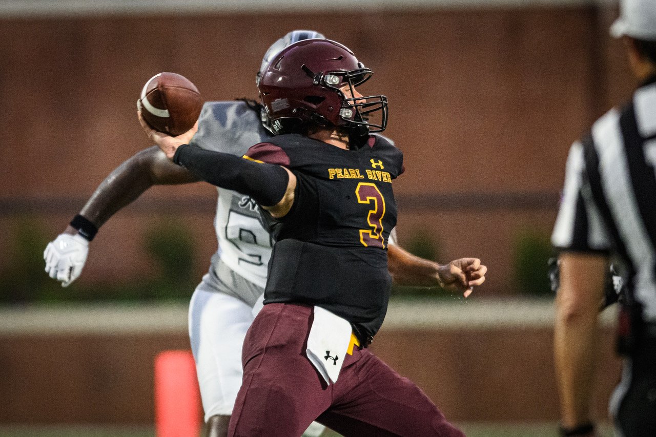 Dustin Allison (Pass Christian) throws a pass against Holmes (Jared Thomas).