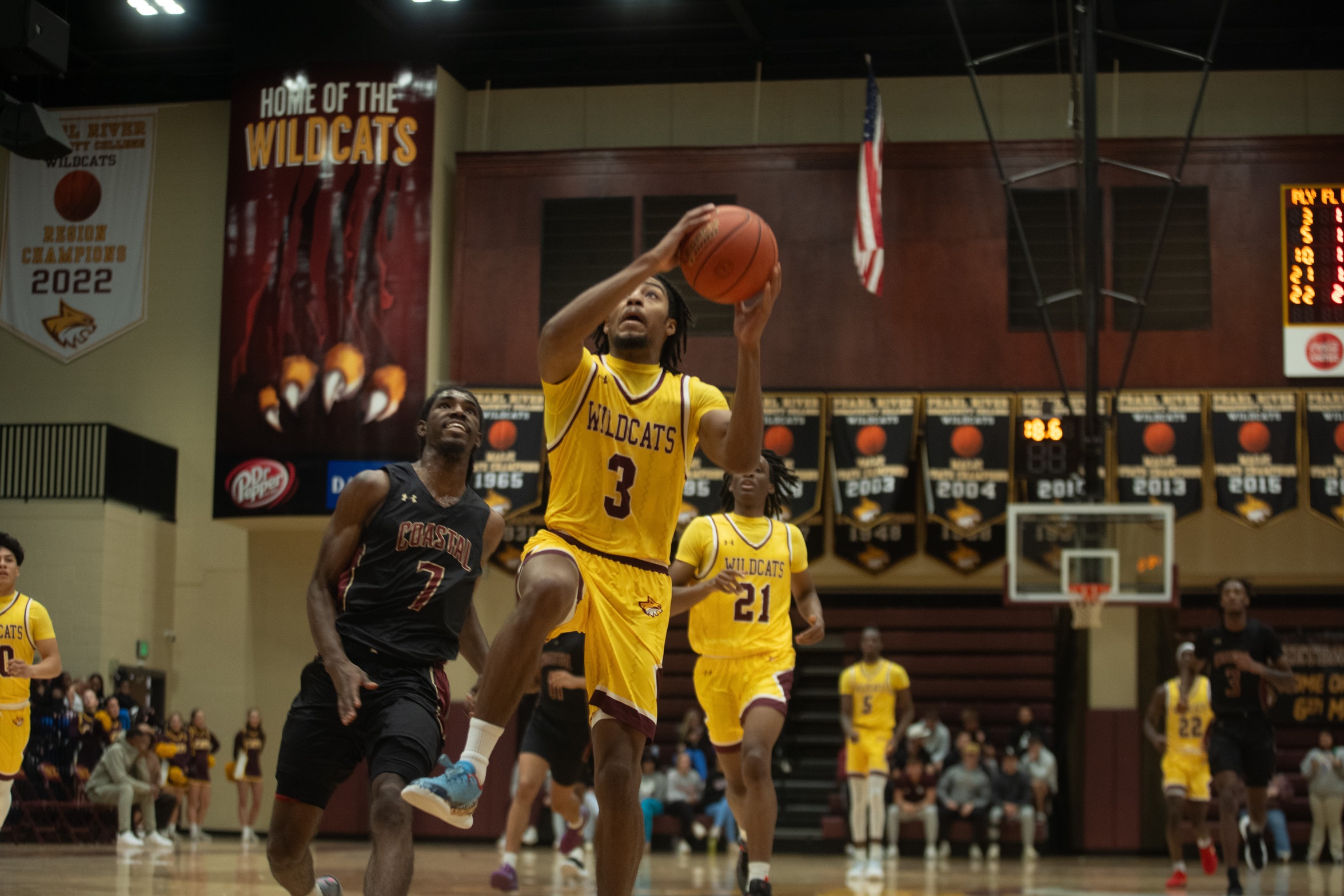 Basketball player is about to lay up a basket.