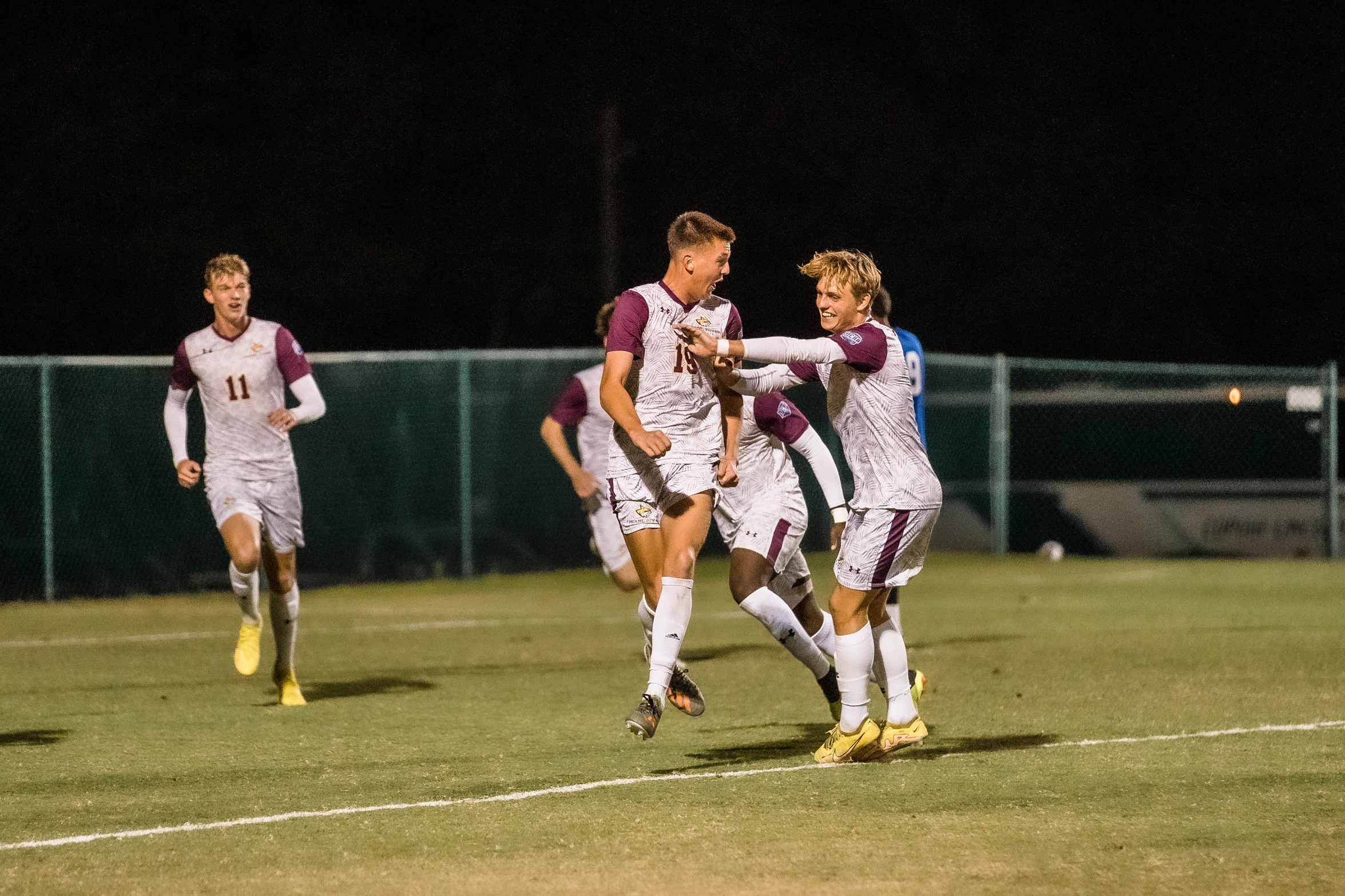Luke Hopkins (Clinton) celebrates with teammate Christopher Dommer (Copenhagen, Denmark) after scoring a goal. (River Roderick/PRCC Athletics)