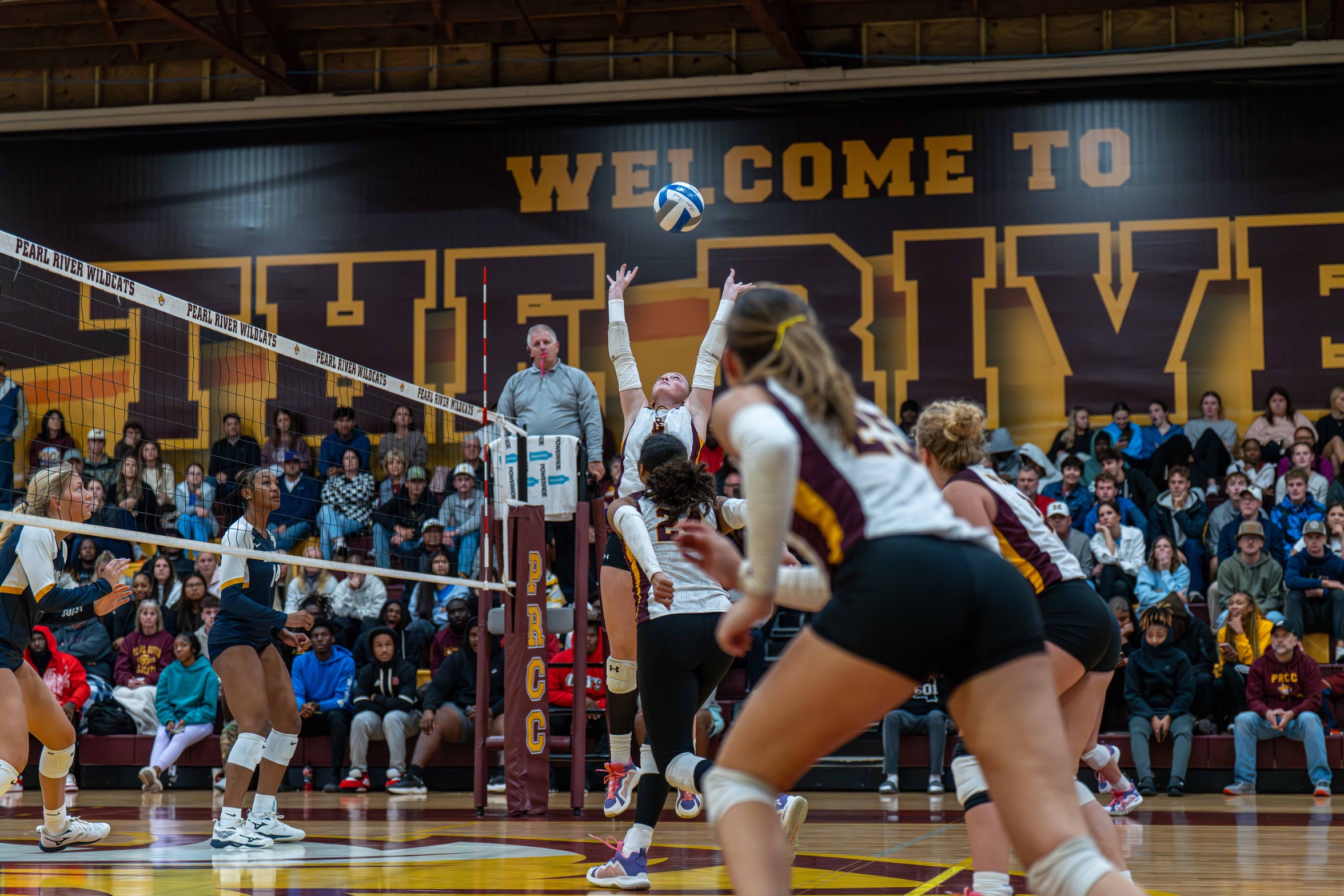 Claire Smith (Coldwater; Lewisburg) sets the ball up as her attackers prepare for a strike (River Roderick/PRCCAthletics).